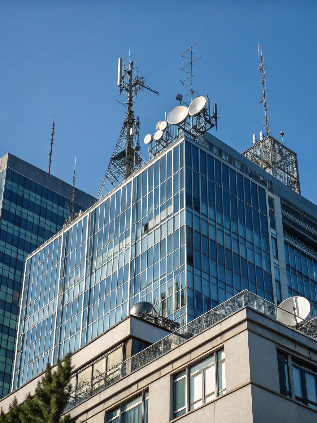 A modern office building with interconnected computer networks displayed in the background, representing enterprise architecture services.